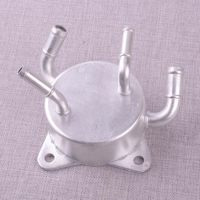 Metal component with multiple pipes on a textured gray background