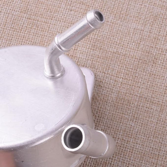 Metallic tea infuser with two prongs on a beige fabric background