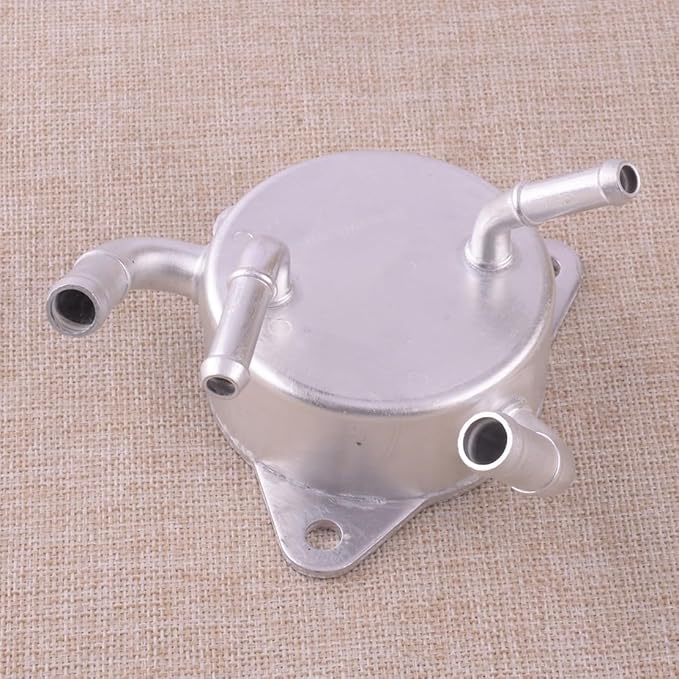 Metallic oil cooler on a textured beige background