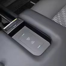 Car interior with a control panel featuring buttons and a display.