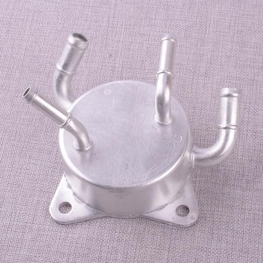 Metal component with multiple pipes on a textured gray background